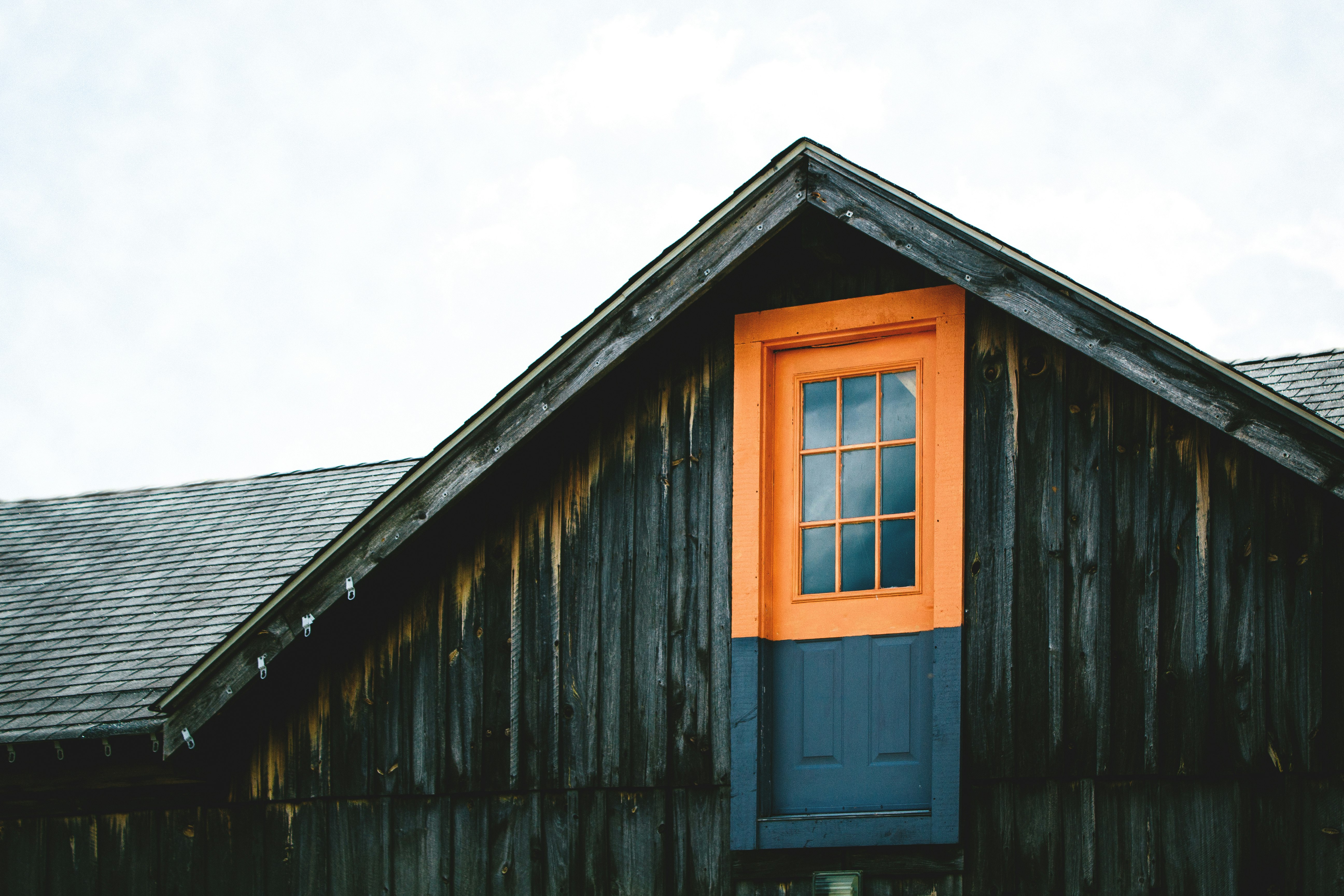 orange and black wooden door on top of house